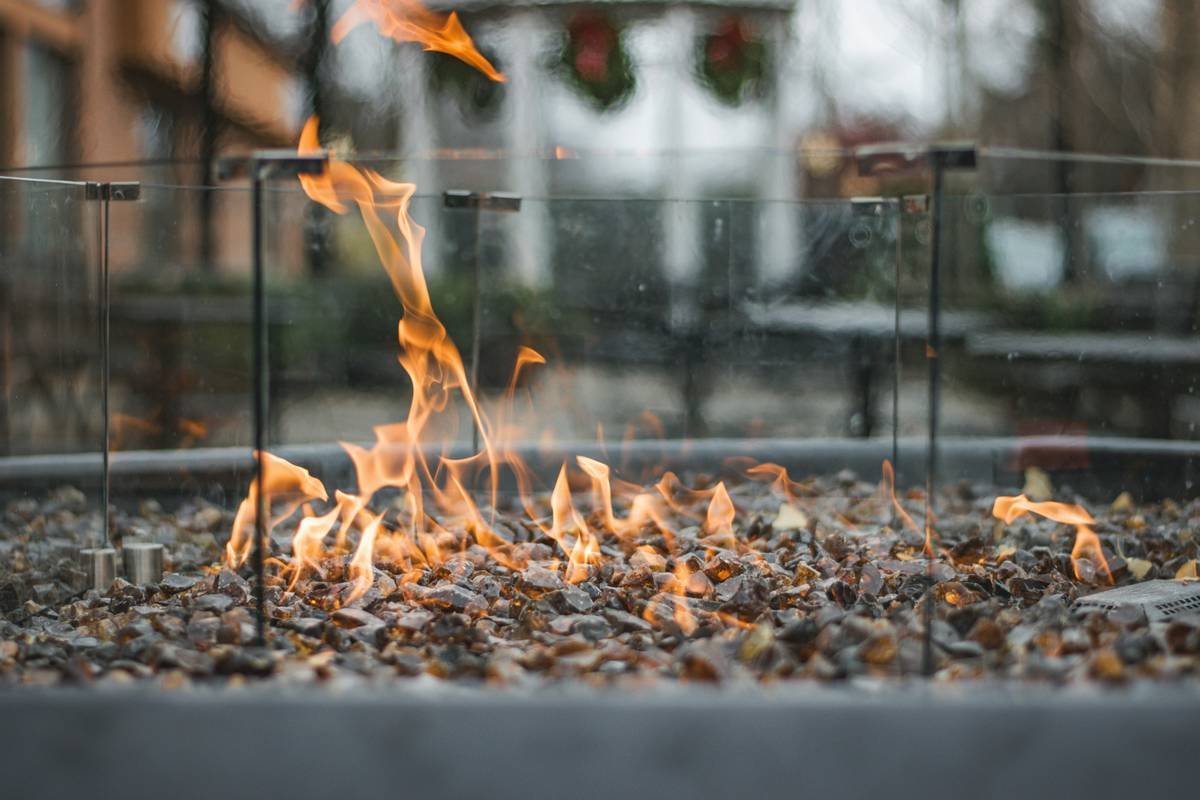 Diagram showing recommended 3-foot clearance around fire pit table from structures, seating, and combustibles