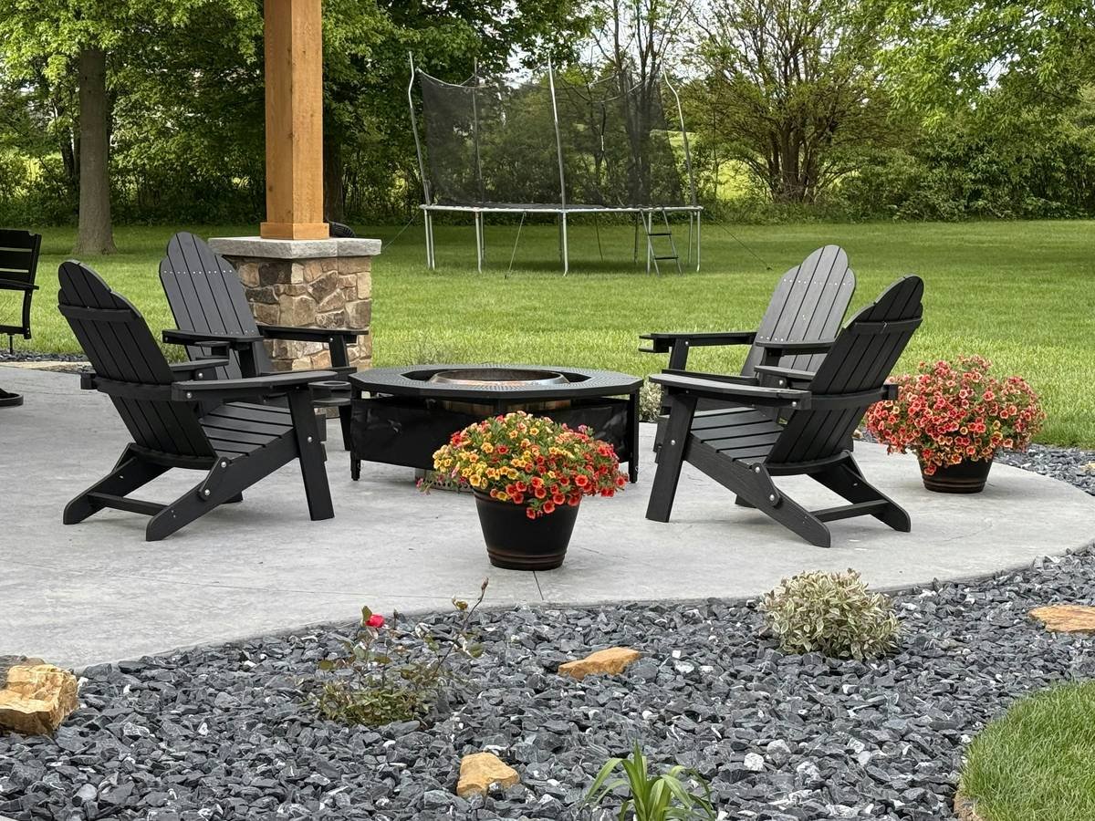 Well-arranged furniture around fire pit with measured spacing and mixed-height seating