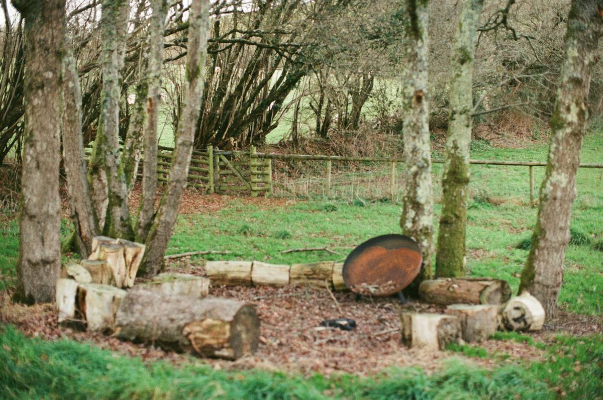outdoor fire pit area diy with curved stone seating and proper clearance