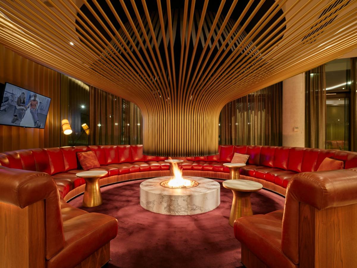 luxury outdoor furniture with fire pit arranged on a stone patio with comfortable seating and ambient lighting